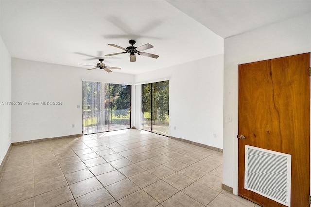 tiled spare room with ceiling fan, visible vents, and baseboards