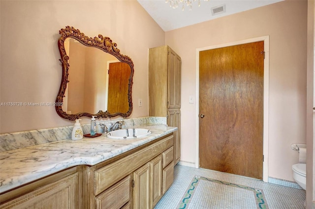 bathroom with visible vents, vanity, toilet, and tile patterned floors