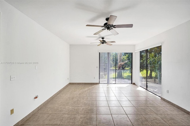 empty room featuring tile patterned flooring and baseboards