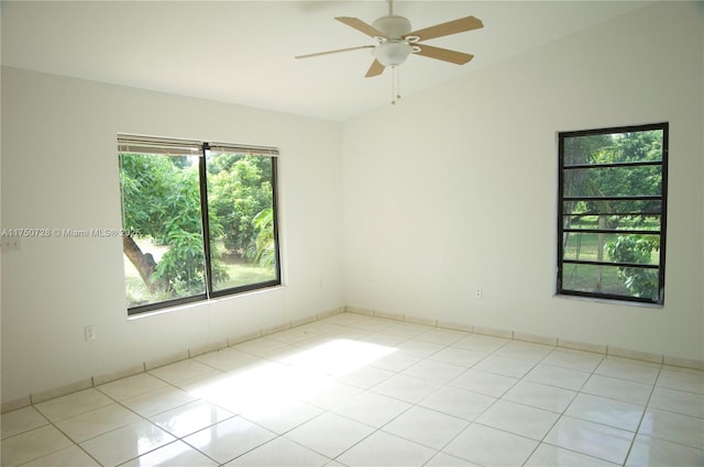 spare room with vaulted ceiling, ceiling fan, and light tile patterned flooring