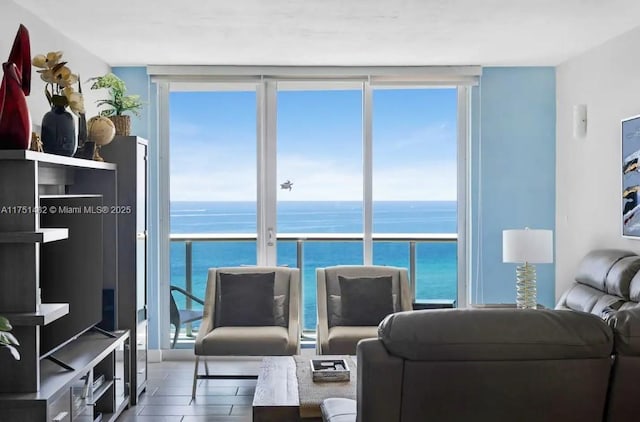 living room featuring expansive windows and a water view