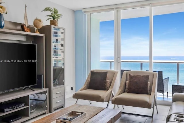 living room with a water view and floor to ceiling windows