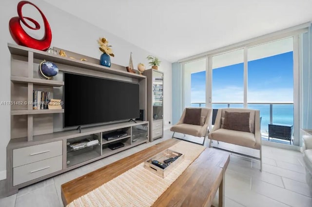 living room featuring light tile patterned floors and expansive windows