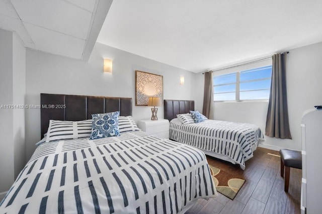 bedroom featuring wood finished floors and baseboards