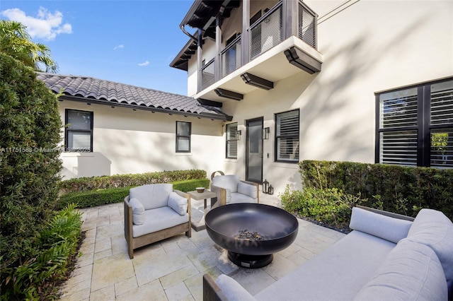 view of patio / terrace featuring an outdoor living space with a fire pit