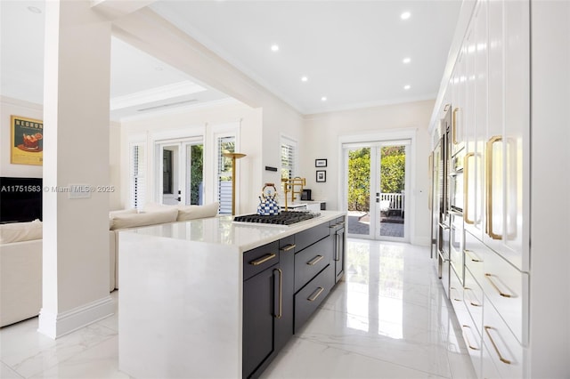 kitchen with a center island, french doors, light countertops, open floor plan, and white cabinets