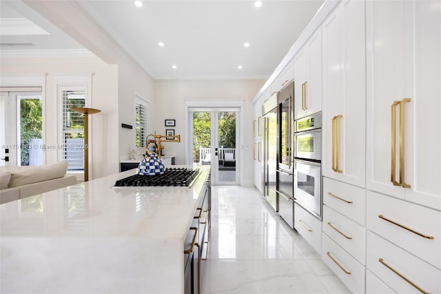 kitchen featuring marble finish floor, plenty of natural light, appliances with stainless steel finishes, and white cabinets