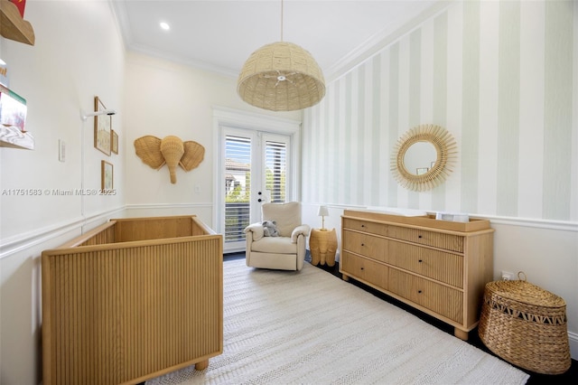 living area with a wainscoted wall, wallpapered walls, crown molding, and recessed lighting