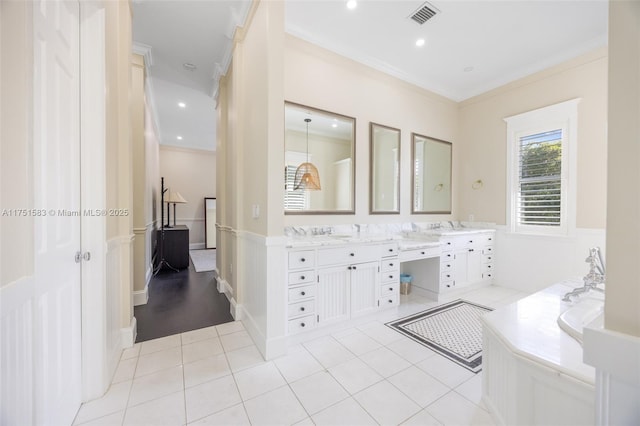 bathroom with double vanity, visible vents, ornamental molding, tile patterned floors, and a garden tub