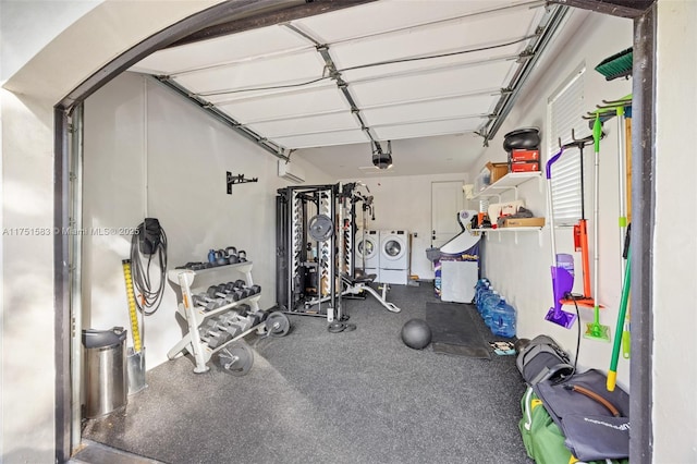 exercise area featuring washing machine and dryer