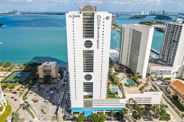 birds eye view of property featuring a water view and a city view