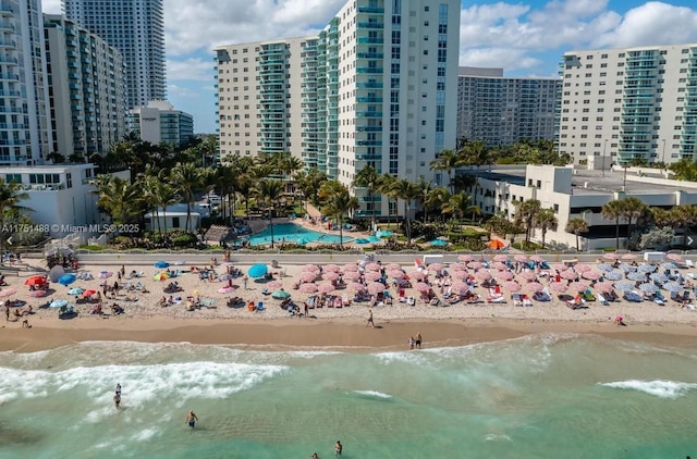 drone / aerial view with a water view, a view of city, and a view of the beach