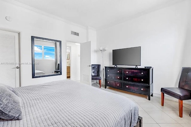 bedroom featuring light tile patterned flooring, visible vents, and crown molding