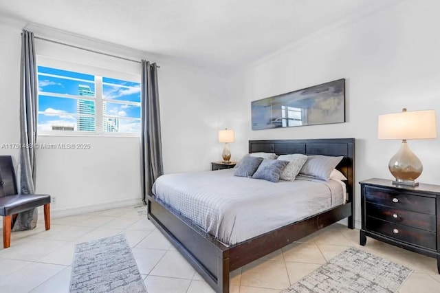 bedroom with light tile patterned flooring and baseboards