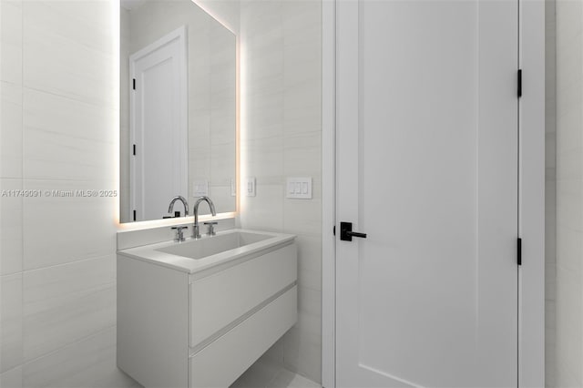 bathroom featuring tile walls and vanity