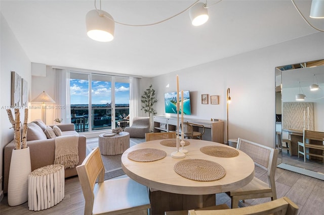 dining room with floor to ceiling windows and wood finished floors