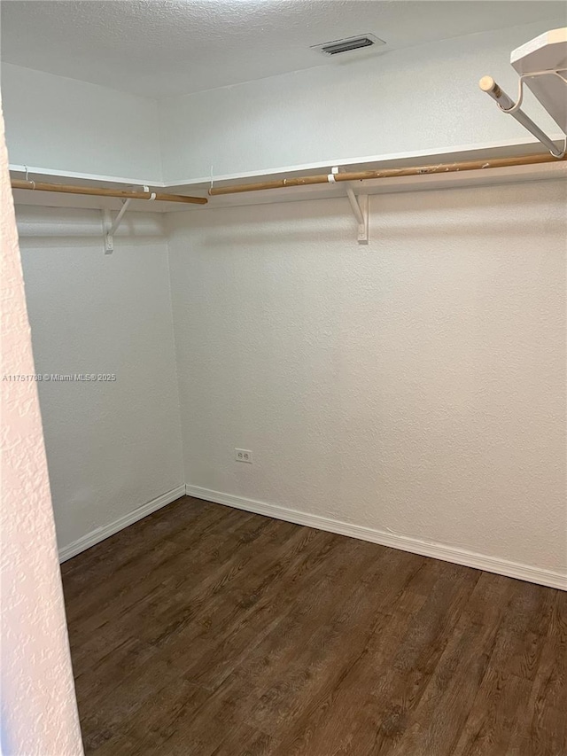 3660 NE 166th St Unit 305, North Miami Beach, FL 33160 - walk in closet with dark wood finished floors