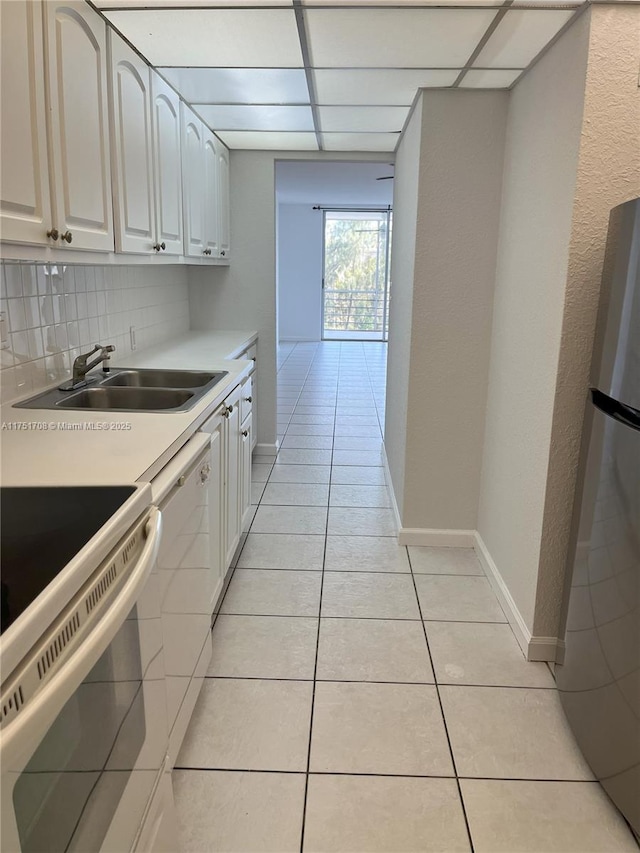 3660 NE 166th St Unit 305, North Miami Beach, FL 33160 - kitchen featuring white appliances, a sink, light tile patterned floors, light countertops, and decorative backsplash
