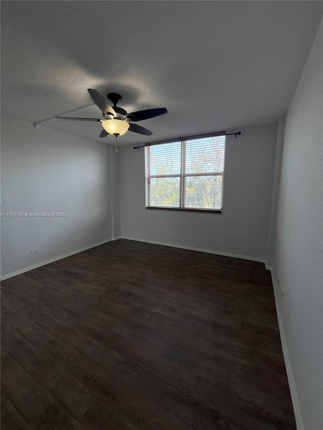 3660 NE 166th St Unit 305, North Miami Beach, FL 33160 - unfurnished room with dark wood finished floors, a ceiling fan, baseboards, and a textured ceiling