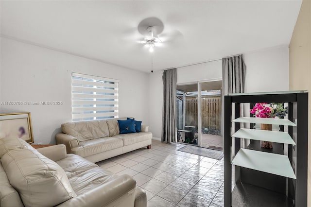 living area with ceiling fan and light tile patterned floors