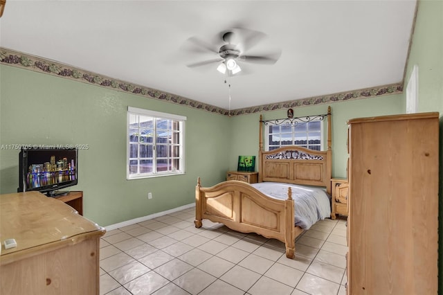 bedroom with light tile patterned floors, ceiling fan, and baseboards