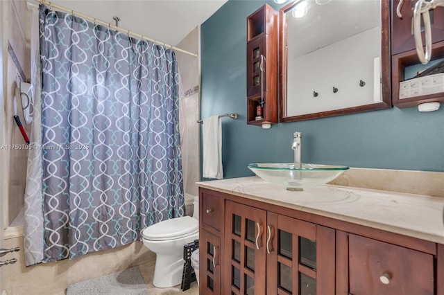 bathroom featuring tile patterned floors, vanity, toilet, and shower / bathtub combination with curtain