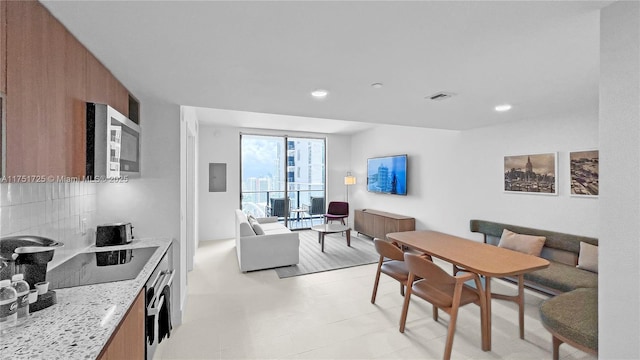 dining space with recessed lighting, electric panel, visible vents, and light floors