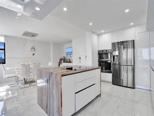 kitchen with modern cabinets, marble finish floor, stainless steel appliances, white cabinetry, and recessed lighting