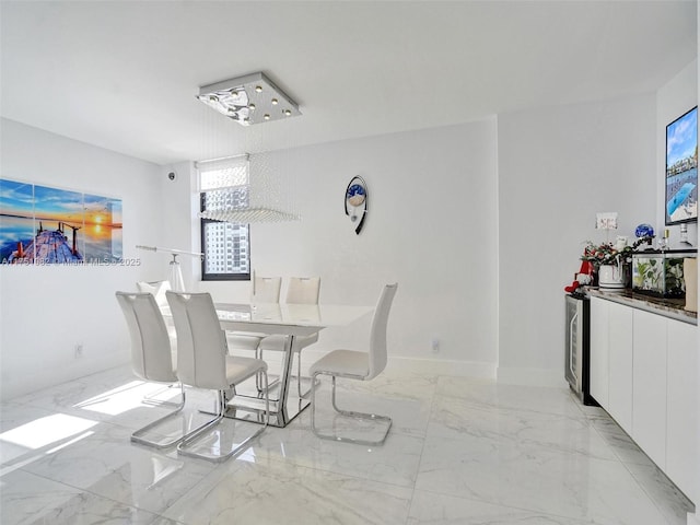 dining space featuring marble finish floor and baseboards