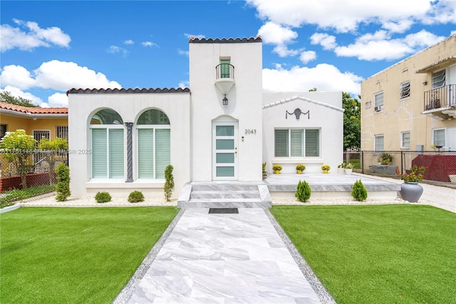 2043 SW 7th St, Miami, FL 33135 - view of front of house with a tiled roof, fence, a front yard, and stucco siding