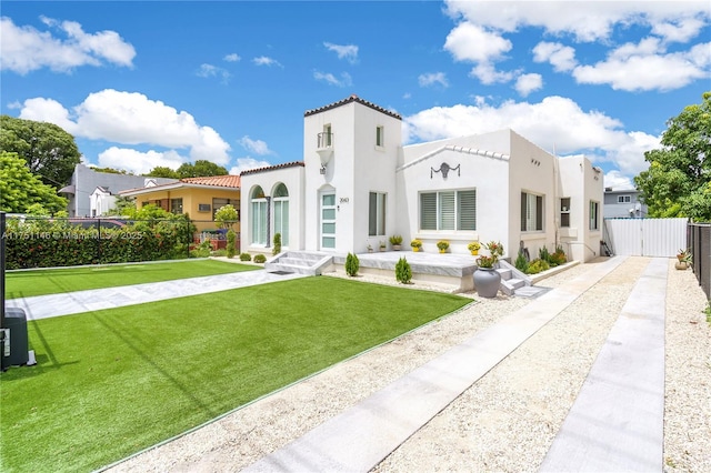 2043 SW 7th St, Miami, FL 33135 - view of front facade featuring fence, stucco siding, a front yard, a gate, and a tiled roof