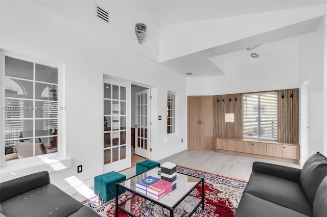 2043 SW 7th St, Miami, FL 33135 - living room featuring wood finished floors, visible vents, french doors, and a towering ceiling