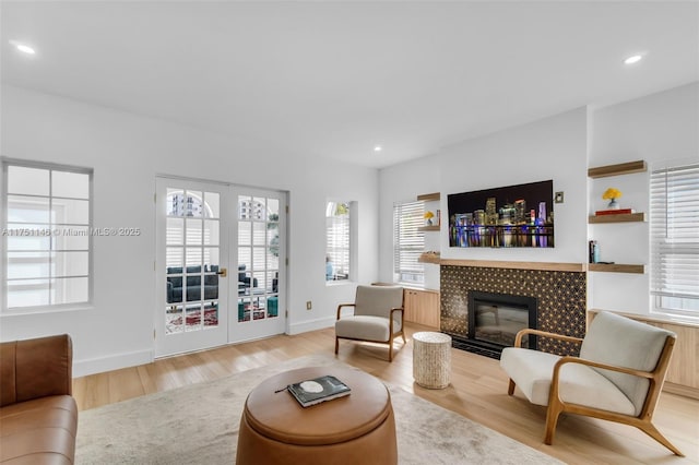 2043 SW 7th St, Miami, FL 33135 - living room featuring a healthy amount of sunlight, a tiled fireplace, recessed lighting, and wood finished floors
