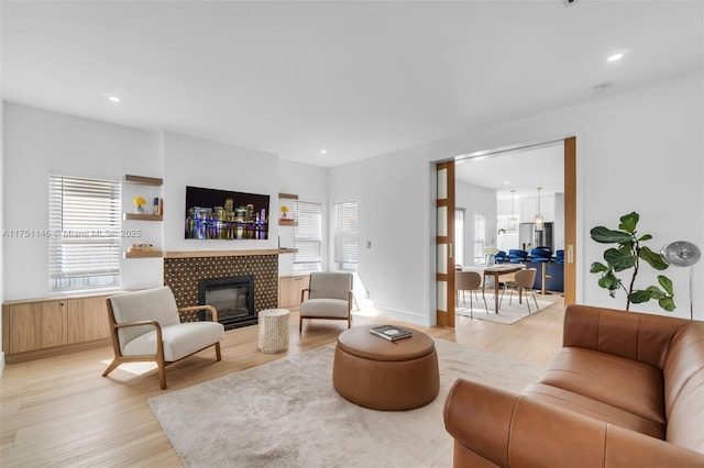 2043 SW 7th St, Miami, FL 33135 - living area with recessed lighting, a tiled fireplace, and light wood-type flooring