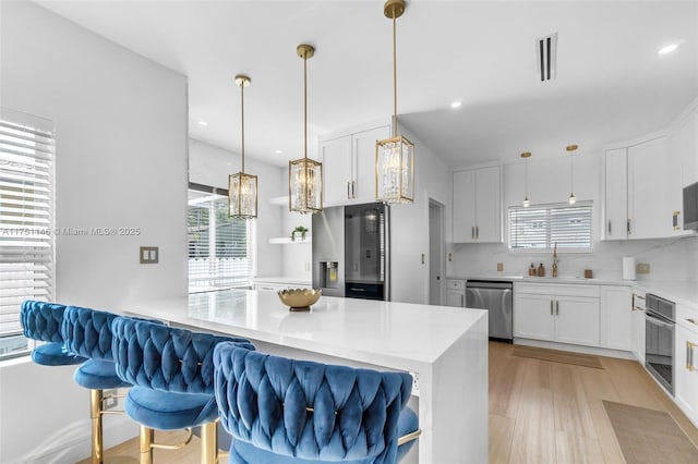 2043 SW 7th St, Miami, FL 33135 - kitchen with a sink, appliances with stainless steel finishes, plenty of natural light, and white cabinetry