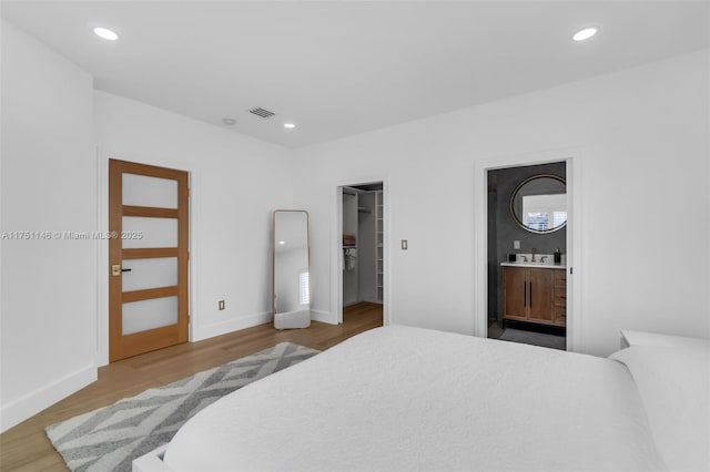 2043 SW 7th St, Miami, FL 33135 - bedroom featuring recessed lighting, a walk in closet, and wood finished floors