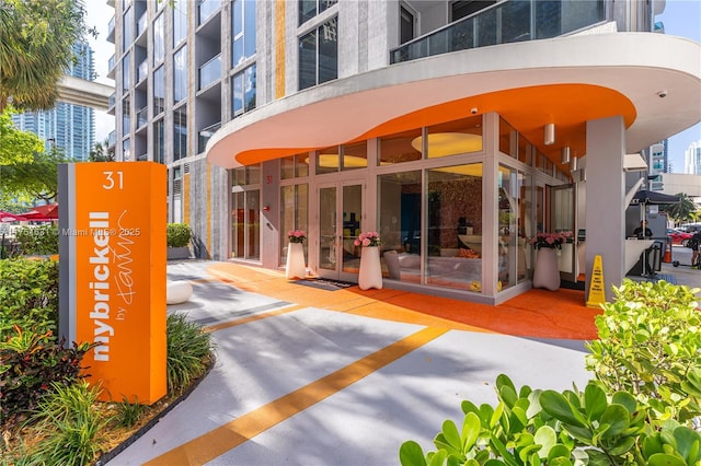 entrance to property with a view of city and stucco siding