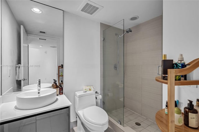 bathroom with a shower stall, visible vents, vanity, and toilet