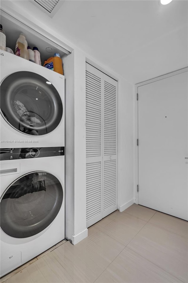 laundry area with stacked washer and dryer and laundry area