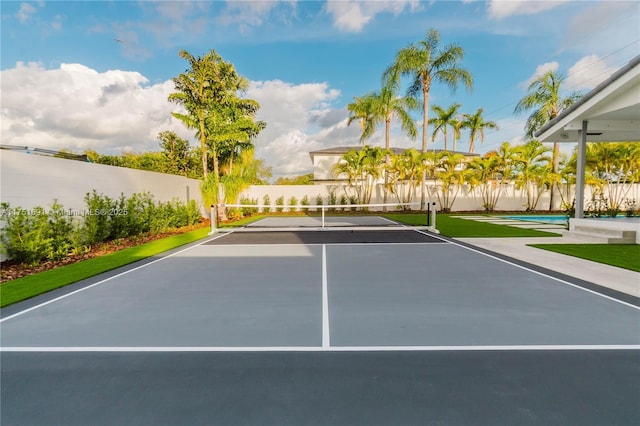 view of tennis court featuring fence