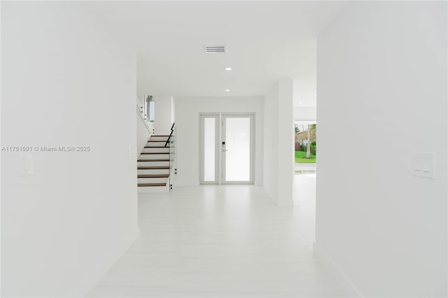 foyer featuring recessed lighting, visible vents, and stairway