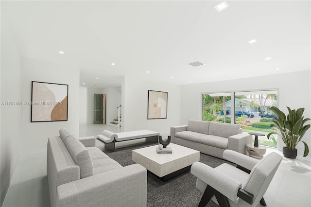 living room featuring recessed lighting, visible vents, and stairs