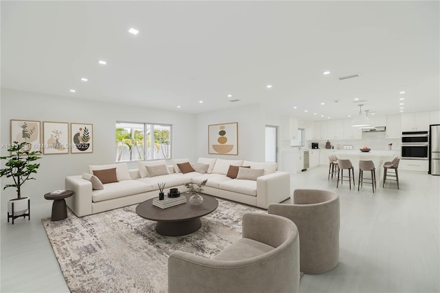 living area with recessed lighting and visible vents