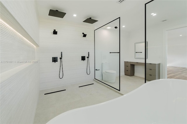 full bathroom featuring toilet, tile patterned flooring, a freestanding tub, a walk in shower, and tile walls