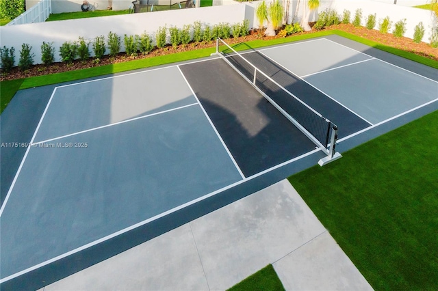 view of tennis court featuring fence