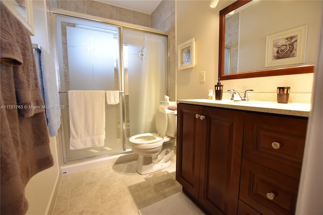 full bath featuring a stall shower, vanity, and toilet