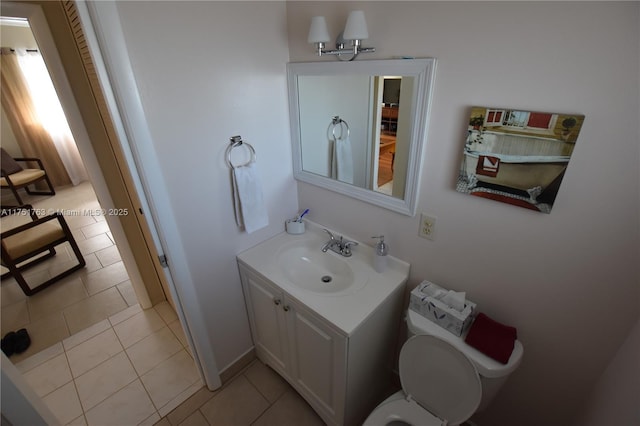 bathroom featuring tile patterned flooring, vanity, and toilet