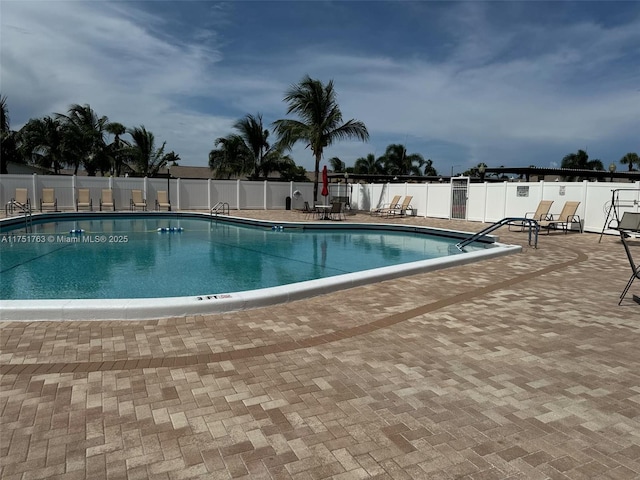 pool featuring a patio area and fence