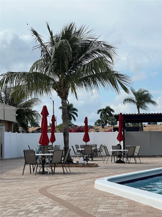 exterior space featuring a patio, outdoor dining area, and fence