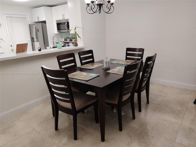 dining space featuring light tile patterned floors, baseboards, and a notable chandelier